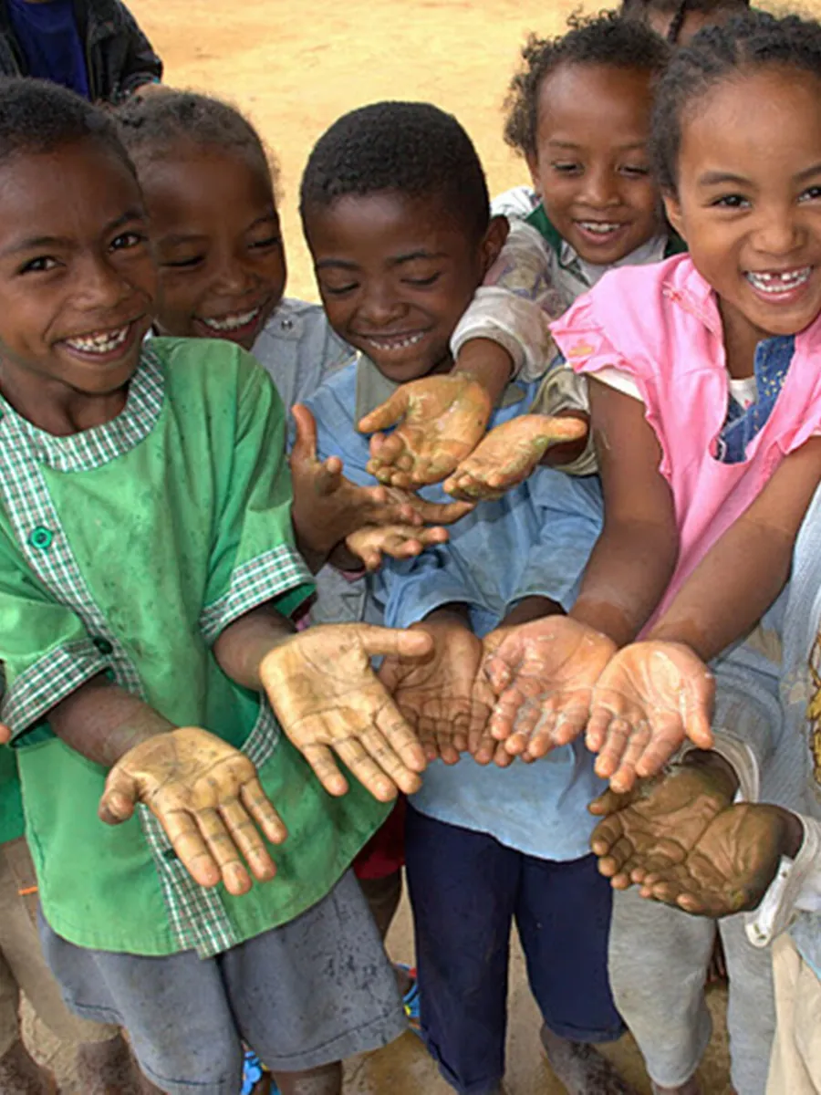 Smiling children show their soapy hands on Global Handwashing Day
